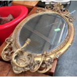 An early 19th century giltwood gesso oval mirror, scrolling acanthus cresting, oval plate, within