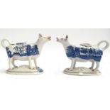 Two 19th century blue and white Staffordshire style cow creamers, each stamped to base 'B' and