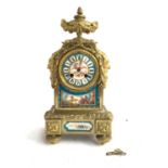 A French brass mantel clock, movement marked H & F Paris, with Watteau style panels and Greenman