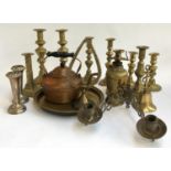 A quantity of pairs of brass candlesticks; various other brass items; copper kettle; and a pair of