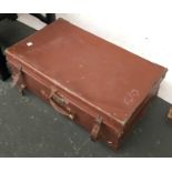A vintage leather suitcase, containing a quantity of ceramics and a table lamp