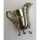 An early 20th century silver milk jug, three feet with lion mask knees (af), 4.1oz