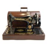 A Singer sewing machine, s/n Y7466552, in a domed mahogany carry case, with key