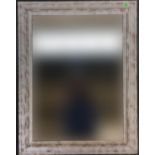 A pine framed wall mirror with distressed paint effect, 70x55cm