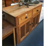 An early 20th century pine sideboard, two drawers above cupboard doors, 145x49x104cmH