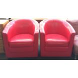 A pair of red vinyl tub chairs
