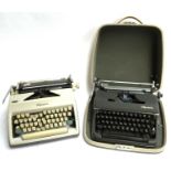 An Olympia De Luxe portable typewriter; together with one other Olympia portable typewriter (2)