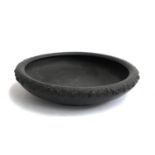A Wedgwood black basalt bowl with grape and vine decoration in relief, 33cmD