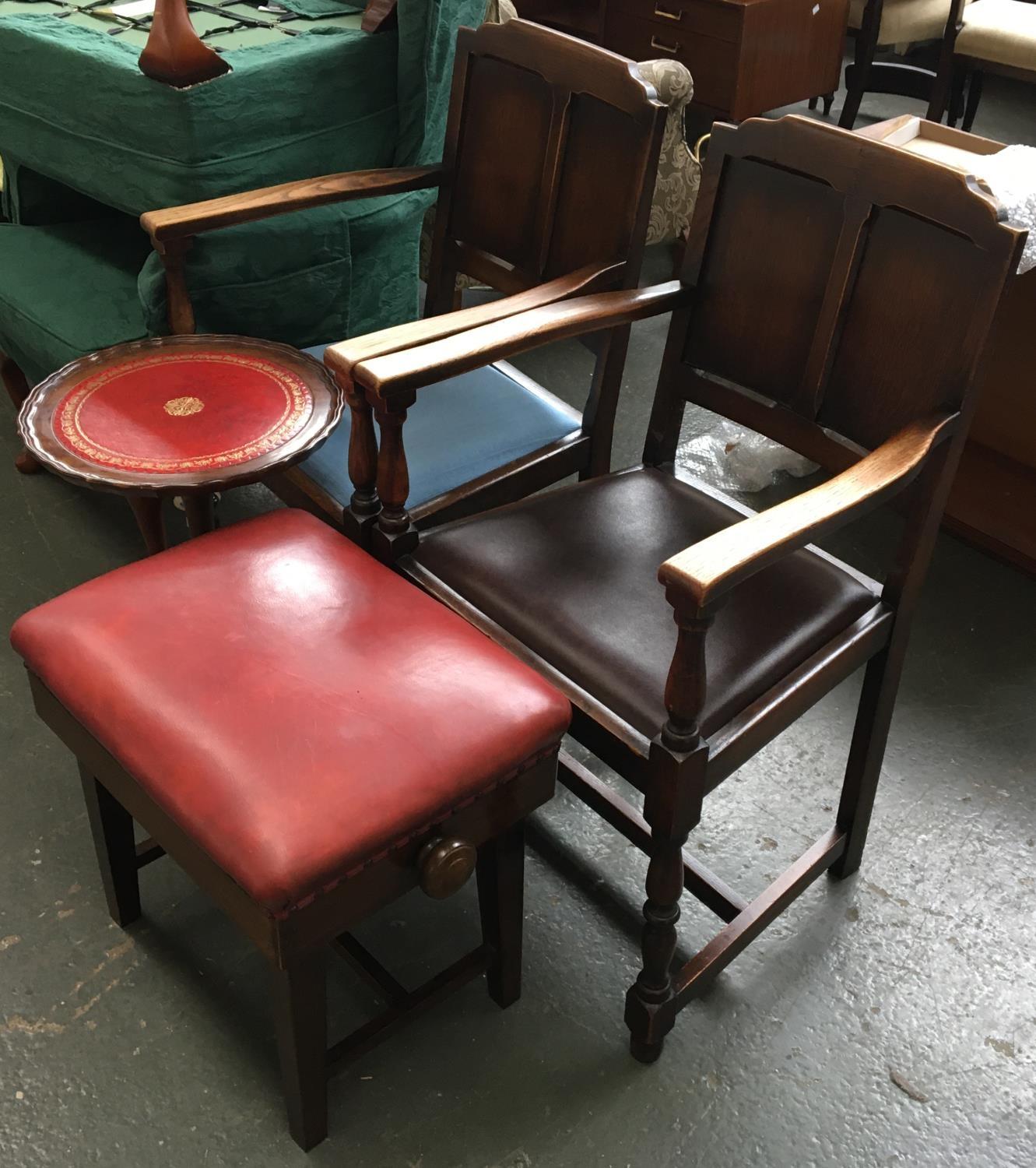 A pair of oak open armchairs, together with a small tripod table and vinyl upholstered piano stool