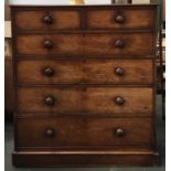 A large Victorian mahogany chest of two short over four long drawers, with turned wooden knobs, on
