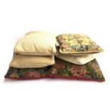 A pair of needlework cushions, one depicting a Medieval scene; together with four others (6)