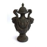 A cast metal lidded urn, with twin scrolling handles and mask decoration, approx. 49cmH