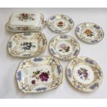 A late 18th/early 19th century part dinner service, hand painted with differing floral designs, to