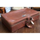 A metal travel trunk, 50cmW; together with a vintage leather suitcase, 72cmW