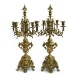 A pair of brass baroque style six-arm candlesticks, with removable snuffers, each 68cmH