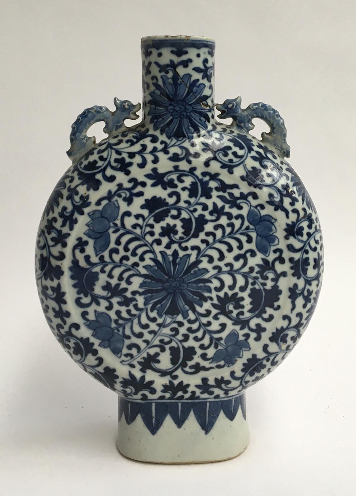 A Chinese blue and white moon vase, Yong Zheng style with dragon lugs and floral motifs, 26cmH