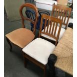 A pair of faux suede upholstered dining chairs; together with one other