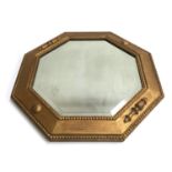 An octagonal gold painted wall mirror with bevelled glass, 55cmW