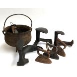 Three 19th century flat irons; three cast irons shoe slobs and a three legged cauldron and oil lamp;