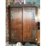 An early 20th century oak corner cupboard