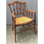 A Victorian walnut open armchair, with caned seat