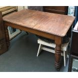 A substantial extending dining table, on turned legs and casters, 130cmW