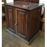 A small oak cabinet with two cupboard doors, 48x33x46cmH