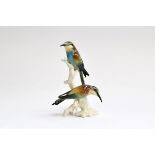 A Karl Ens porcelain figurine of two bee-eaters perched on a branch (af), marked to base, 22.5cm