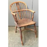 A 19th century Windsor chair, pierced splatback, the arms on turned front supports, shaped elm seat,