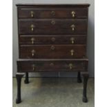 A largely late 16th century oak chest on stand, the top comprising four drawers, the base with a
