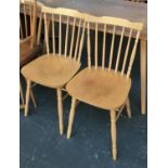 Two stick back chairs, together with a demilune side table