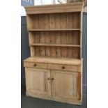 A Victorian pine dresser, two shelves above base, two drawers and two cupboard doors, 131x49x210cmH