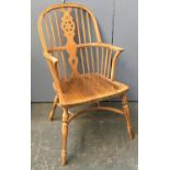 A large wheelback windsor chair, the arms on bentwood front supports, turned legs joined by