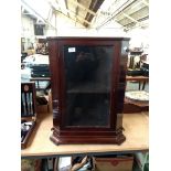 A small mahogany corner cupboard with single shelf and glazed door, 67cm