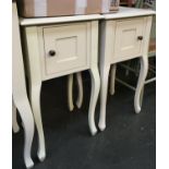 A pair of white painted bedside tables, by Laura Ashley Home, each with single cupboard door and