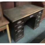 An early 20th century oak kneehole desk, with the traditional arrangement of drawers, 122cmW