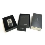 A Vertu flip phone, serial no. F-029106, unused in box; together with a Vertu phone charger, boxed