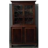 A mahogany library bookcase with satinwood inlay and astragal glazing, the cupboard containing two