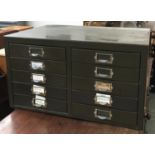 A metal filing cabinet with two sets of five drawers, 55cmW
