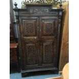 A heavily carved continental cabinet, comprising four doors with internal shelves, 100cmW 189cmH