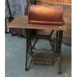 A Vickers model deluxe sewing machine and table, with cast iron treadel and mahogany hooped cover