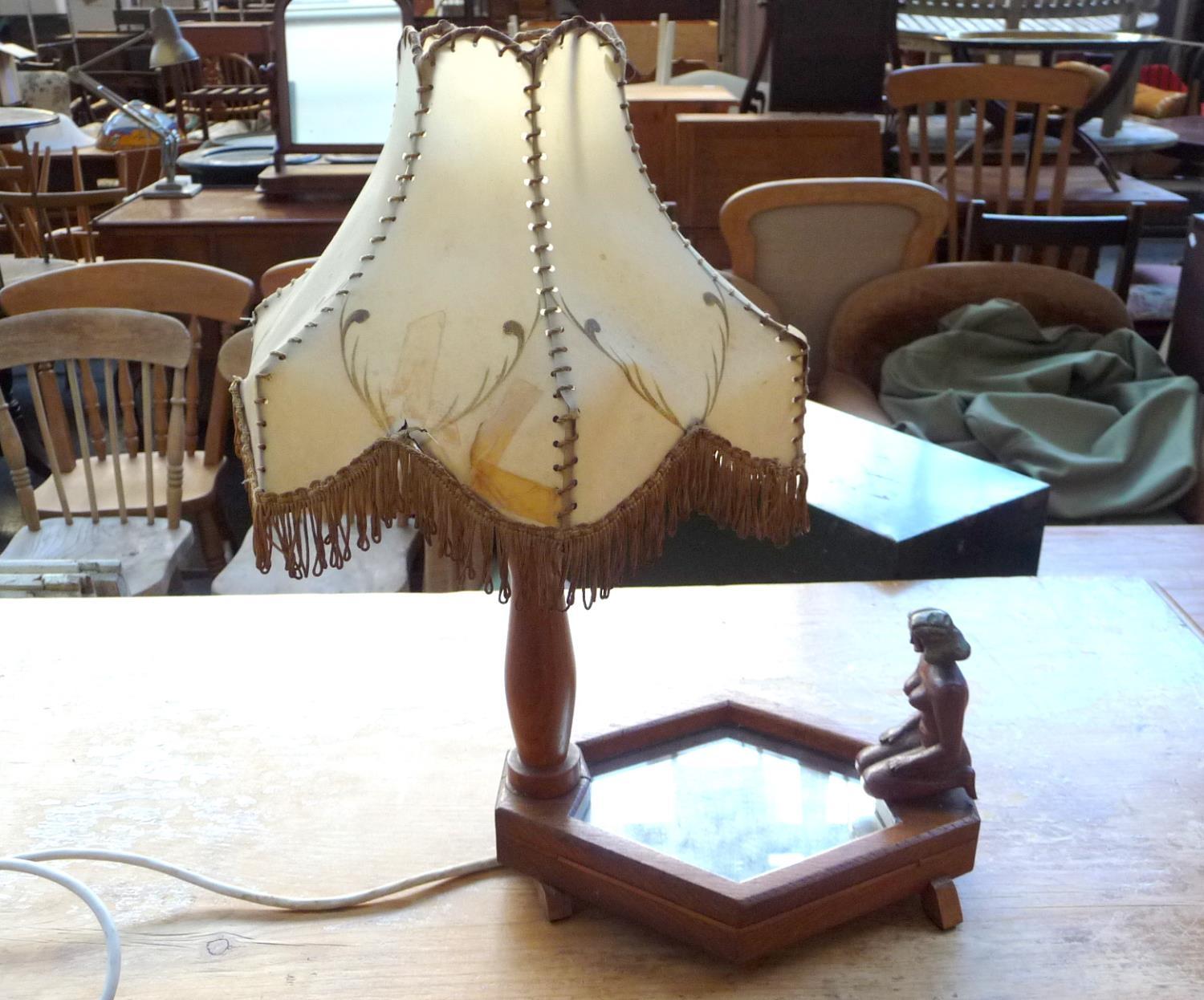 A lamp with carved woman gazing into pool