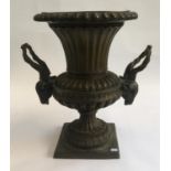 A cast metal urn, twin handles formed as horned beasts, 51cmH