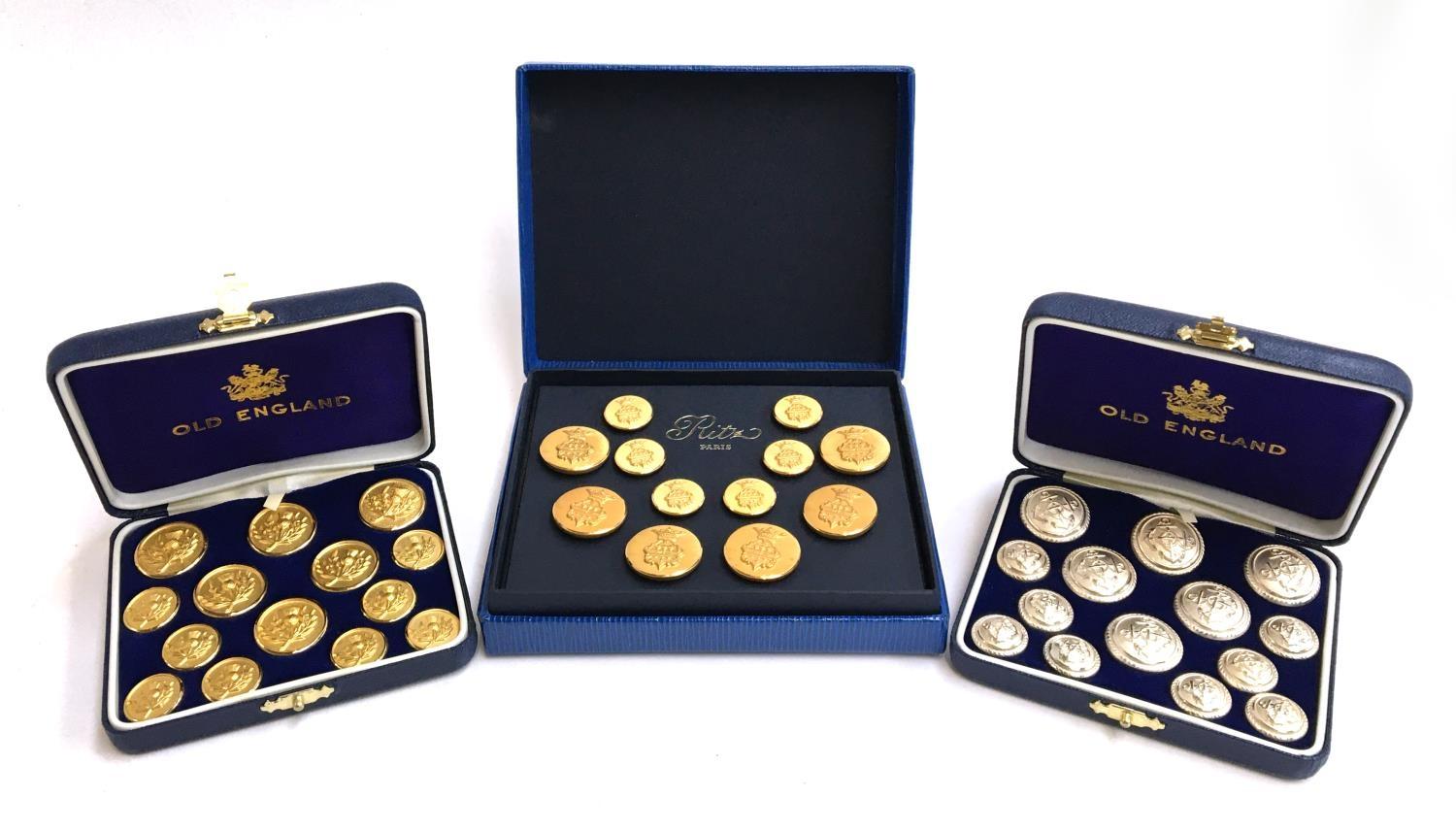 A boxed set of Old England Thistle blazer buttons; a boxed set of Old England anchor buttons; and