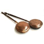 A pair of long handled copper bed warming pans