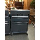 A metal tool organiser on lockable casters, comprising a number of drawers over cupboard, 60cmW