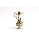 A floral encrusted porcelain bottle, heightened in gilt and decorated with insects, underglazed with