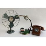 A Castrol pump ornament; modern rotary wood effect telephone and a converted fan clock