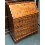 A modern walnut veneer bureau, 76cmW; together by a small drum table by the same maker