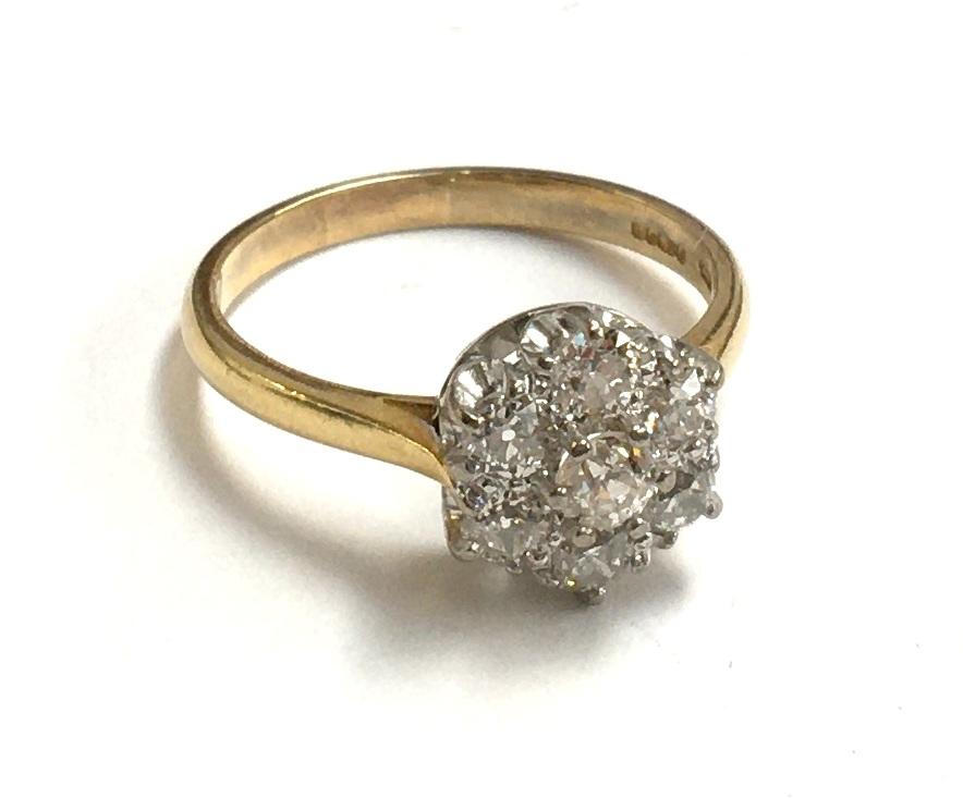 18ct gold ring set with 7 diamonds in a floral cluster gross weight 4.7g, approx 1.2 carats